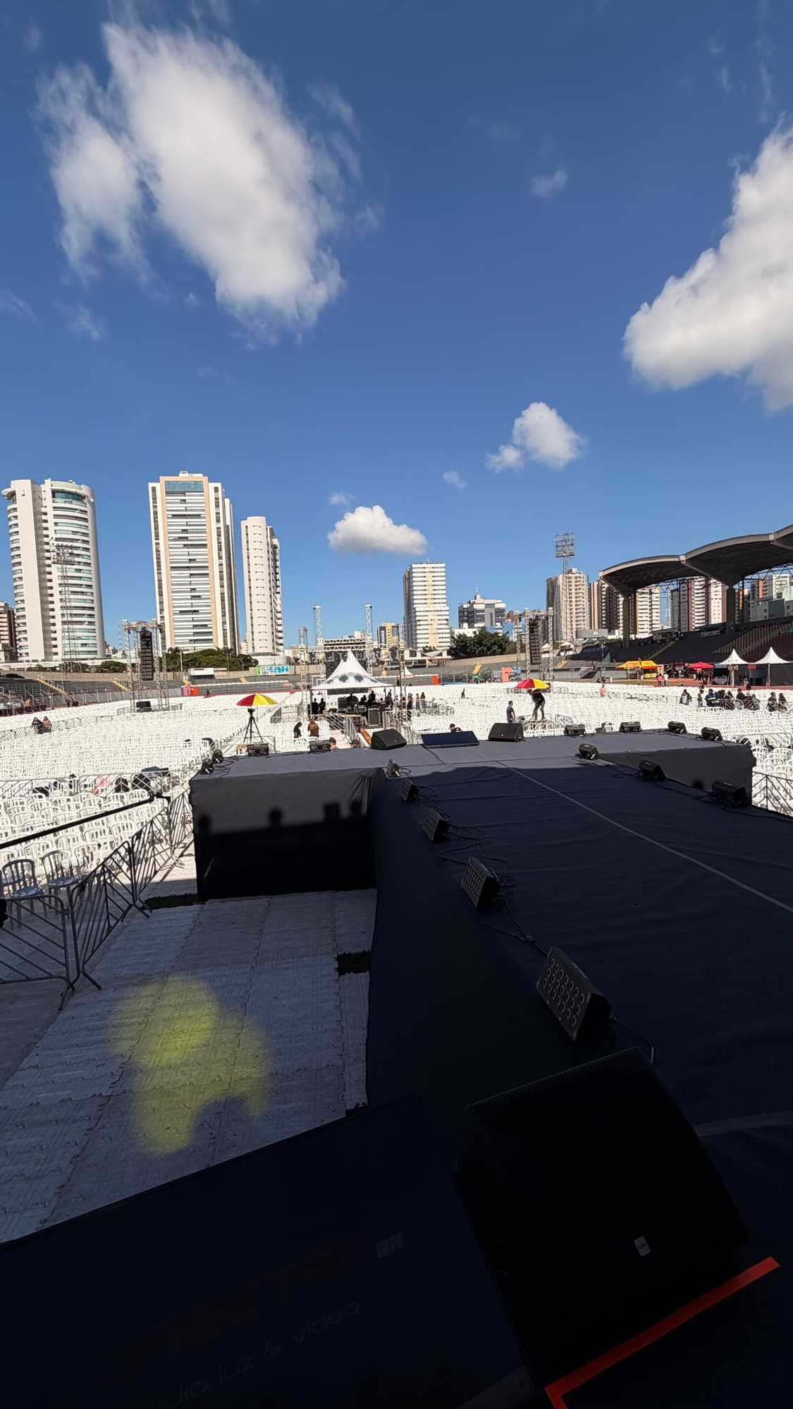 Field of empty white chairs and the stage at Willie Davids stadium before the gates open, Milagres Maringá