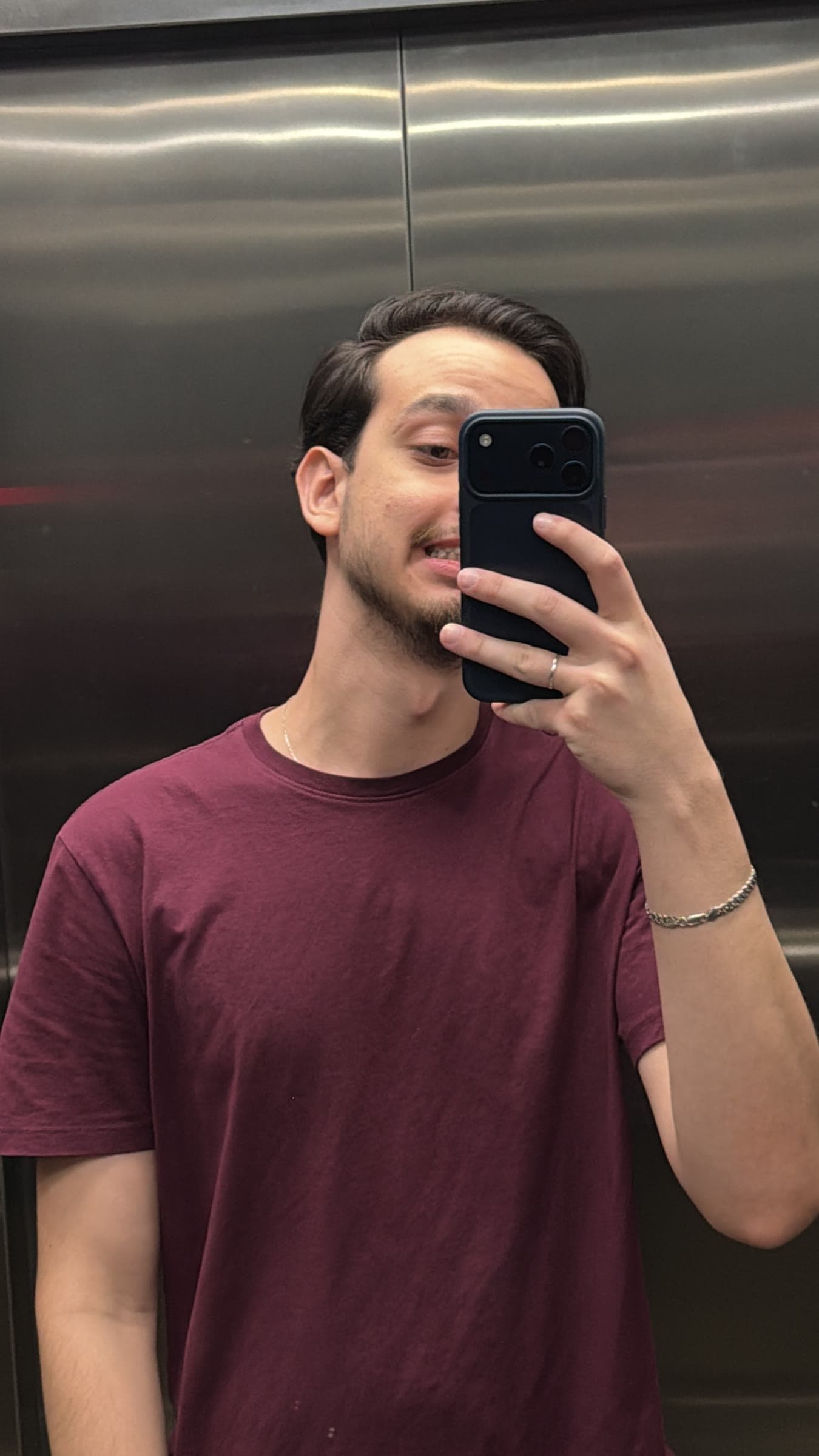 Pedro taking a mirror selfie inside an elevator